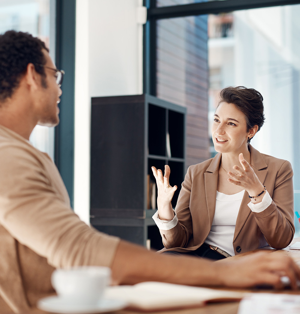 Mentor, Training And A Woman Manager With An Employee In The Office For Coaching On Company Vision. Management, Meeting And A Female Business Person Talking To A Professional Male Colleague At Work Mentor, Training And A Woman Manager With An Employee In The Office For Coaching On Company Vision. Management, Meeting And A Female Business Person Talking To A Professional Male Colleague At Work