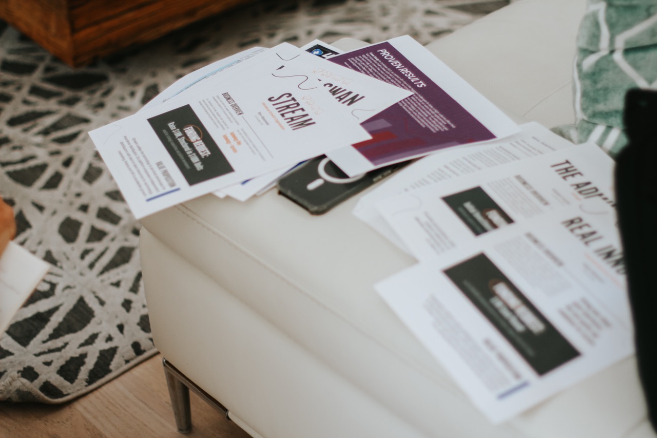 One-pagers scattered on a couch cushion