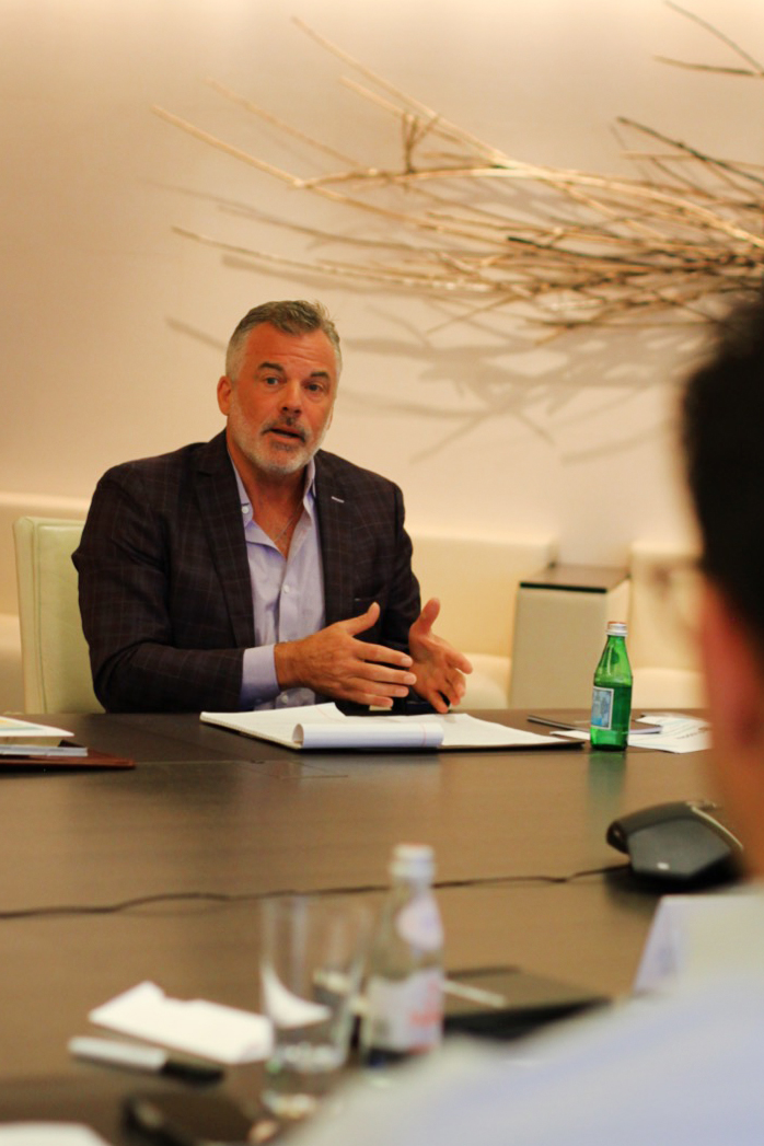 Man sitting at table talking to group