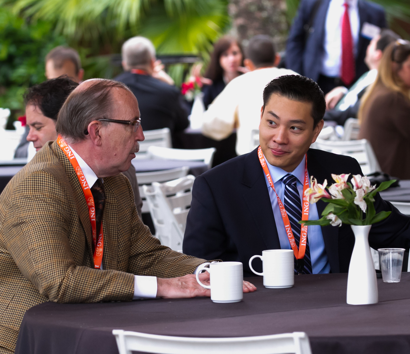James Speaking to Man at Table
